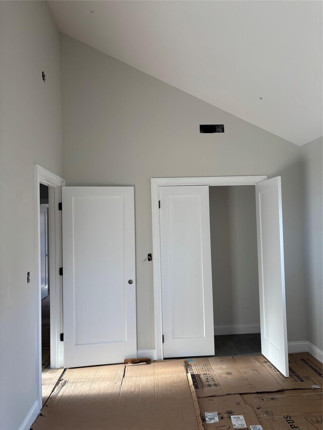 67 2nd St W, Mount Vernon, NY 10550 - unfurnished bedroom featuring baseboards and high vaulted ceiling