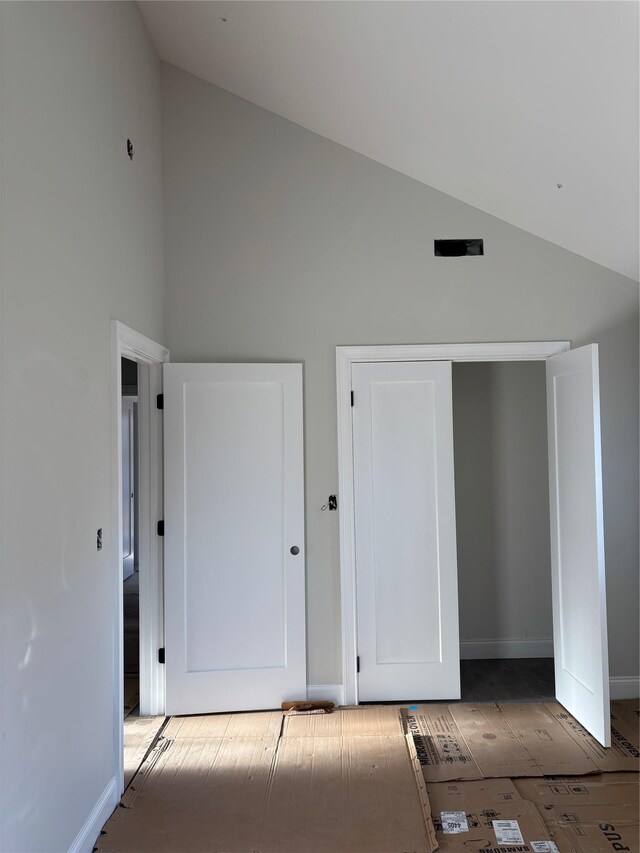 67 2nd St W, Mount Vernon, NY 10550 - unfurnished bedroom featuring baseboards and high vaulted ceiling