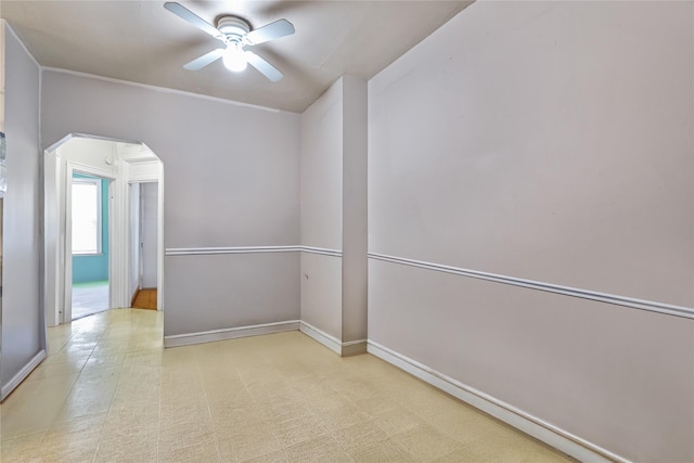 1816 21st Dr, Astoria, NY 11105 - spare room with arched walkways, a ceiling fan, and baseboards
