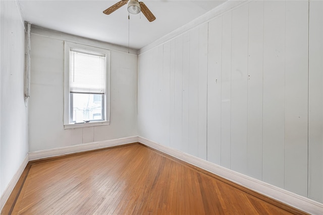 1816 21st Dr, Astoria, NY 11105 - empty room with wood finished floors, a ceiling fan, and baseboards