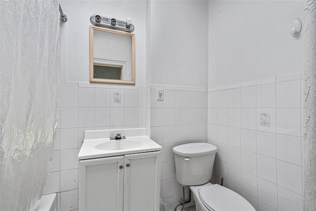 1816 21st Dr, Astoria, NY 11105 - bathroom featuring tile walls, a wainscoted wall, vanity, and toilet
