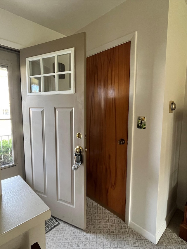 doorway to outside featuring baseboards