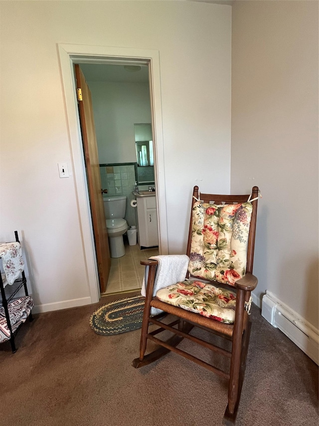 living area featuring baseboards, carpet floors, and a baseboard radiator