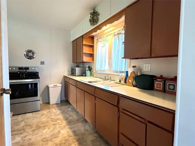 kitchen featuring open shelves, stainless steel appliances, light countertops, and a sink