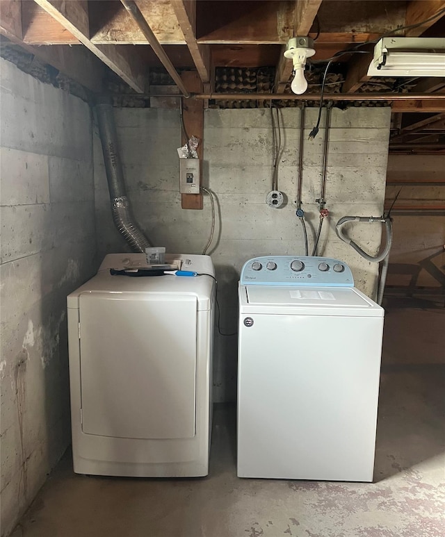 washroom with washing machine and clothes dryer and laundry area