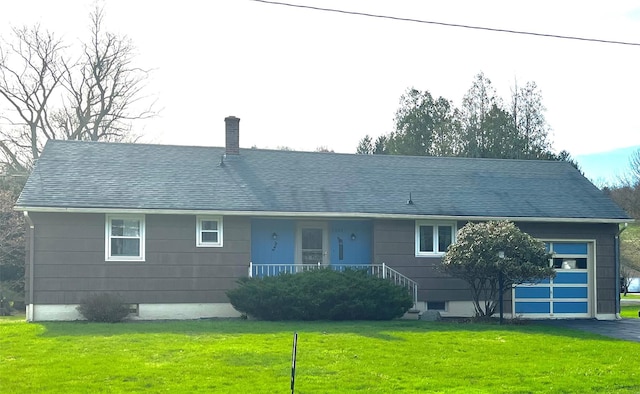 single story home with a chimney, driveway, roof with shingles, a front yard, and a garage