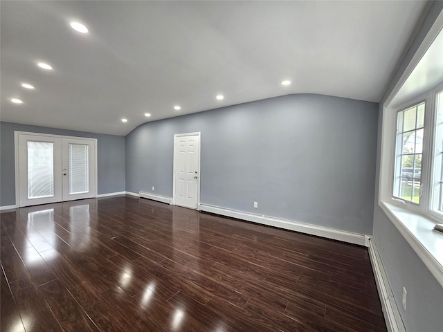 spare room featuring recessed lighting, vaulted ceiling, dark wood-type flooring, and a baseboard radiator