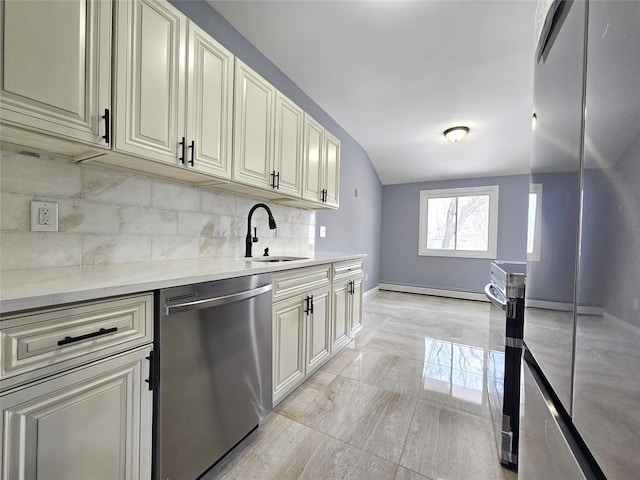 kitchen with decorative backsplash, stainless steel dishwasher, a sink, baseboard heating, and baseboards