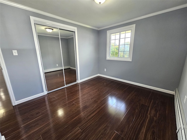 unfurnished bedroom with wood finished floors, a baseboard radiator, a closet, ornamental molding, and baseboards