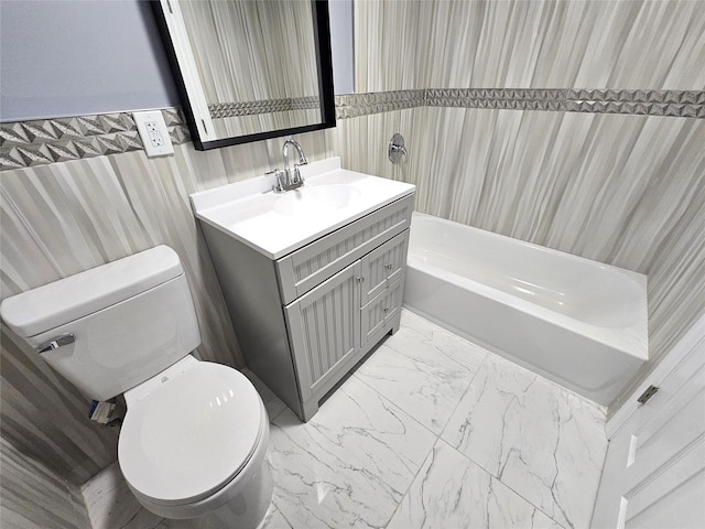 full bath featuring vanity, toilet, marble finish floor, and shower / bath combination