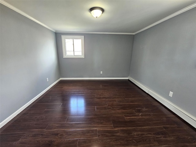 spare room featuring a baseboard heating unit, ornamental molding, wood finished floors, and baseboards