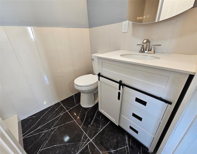 half bathroom with toilet, vanity, and marble finish floor