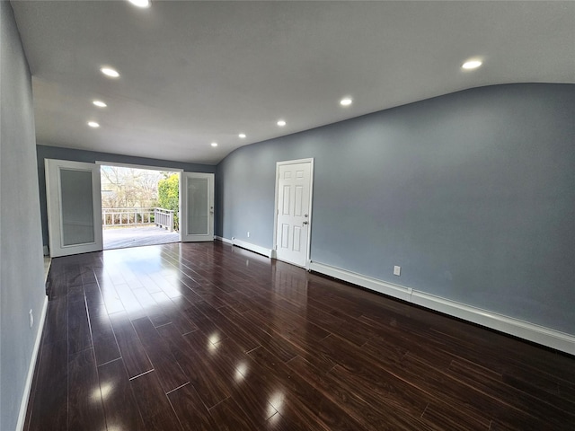 empty room with recessed lighting, baseboards, a baseboard heating unit, and dark wood finished floors