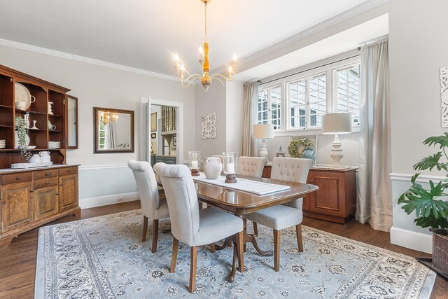 dining room featuring a chandelier, crown molding, baseboards, and dark wood-style flooring