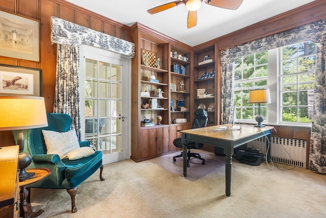 carpeted office featuring radiator and a ceiling fan