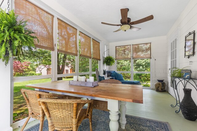 sunroom / solarium featuring ceiling fan