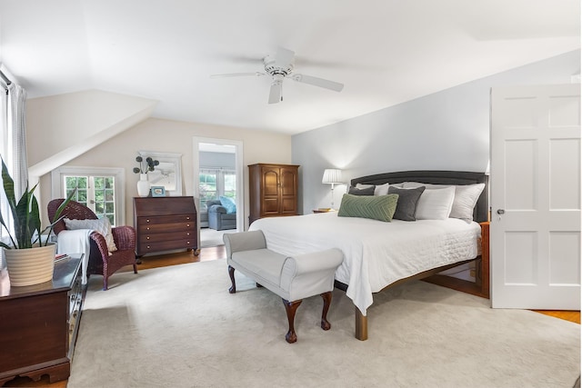 bedroom with a ceiling fan, lofted ceiling, and light wood finished floors