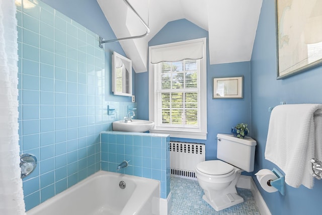 full bathroom featuring radiator heating unit, a sink, lofted ceiling, tile patterned floors, and toilet