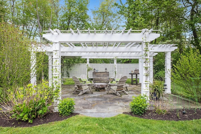 view of patio with a fire pit, a pergola, and fence