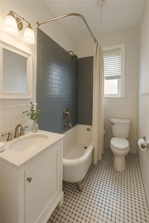 86-03 102nd St Unit 2D, Richmond Hill, NY 11418 - full bath featuring wainscoting, vanity, shower / tub combo with curtain, tile walls, and toilet