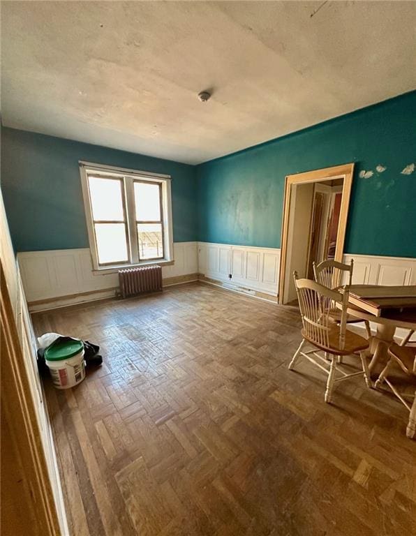 86-03 102nd St Unit 2D, Richmond Hill, NY 11418 - interior space featuring wainscoting, a textured ceiling, and radiator