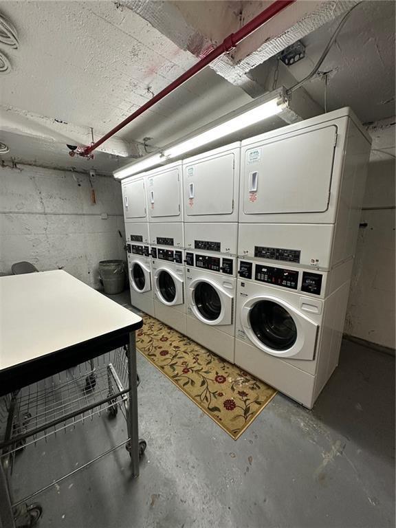 86-03 102nd St Unit 2D, Richmond Hill, NY 11418 - community laundry room with stacked washing maching and dryer