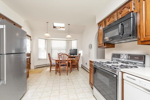 kitchen with white dishwasher, black microwave, gas stove, freestanding refrigerator, and a baseboard heating unit