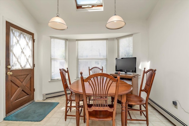 dining space featuring a baseboard heating unit, plenty of natural light, and vaulted ceiling