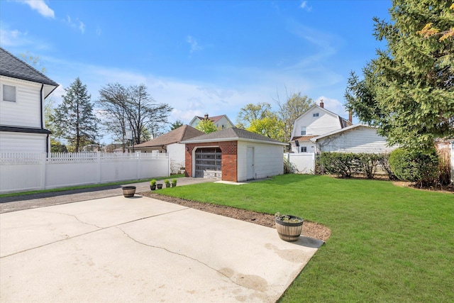rear view of property with a fenced backyard, a detached garage, an outbuilding, and a yard