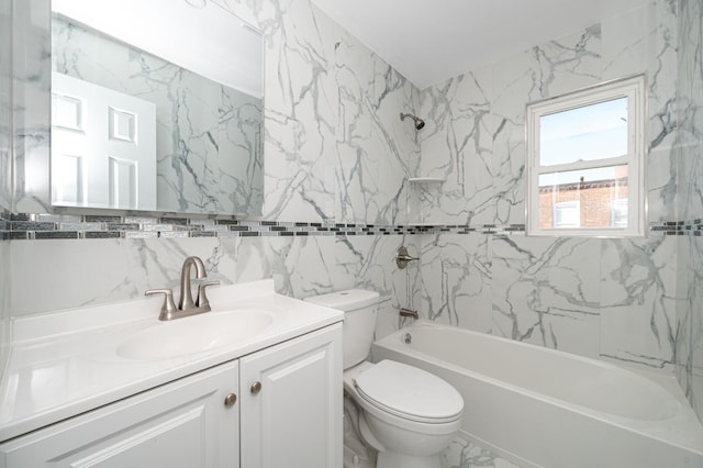 full bathroom featuring marble finish floor, shower / bathtub combination, toilet, vanity, and tile walls