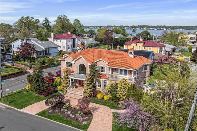 view of front of home featuring a residential view, a tile roof, and a balcony