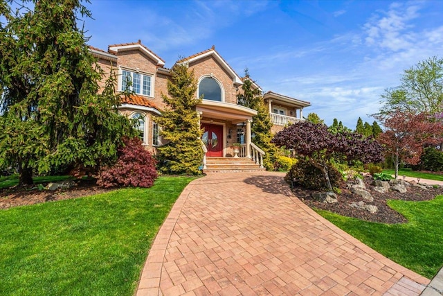 view of front of house featuring a tile roof and a front yard