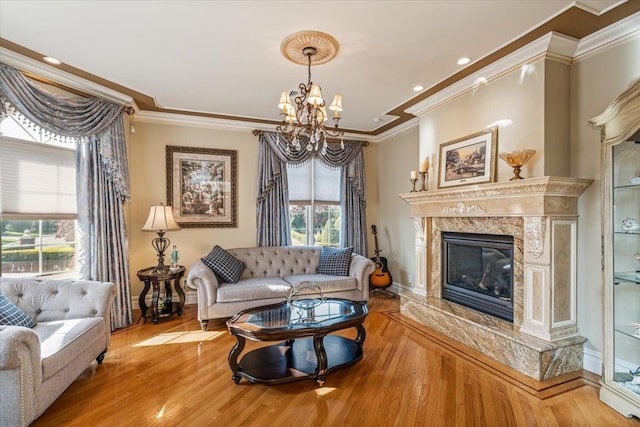 living room featuring an inviting chandelier, baseboards, and ornamental molding