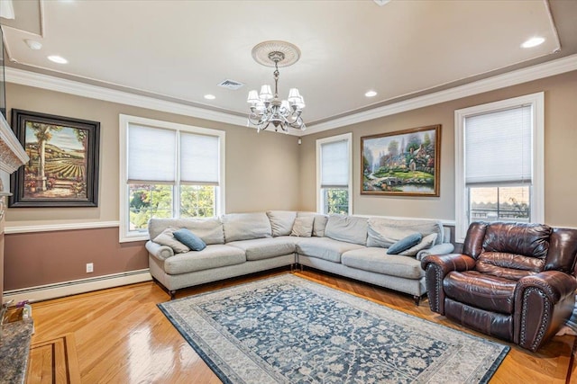 living room featuring a wealth of natural light, a baseboard radiator, a chandelier, and visible vents