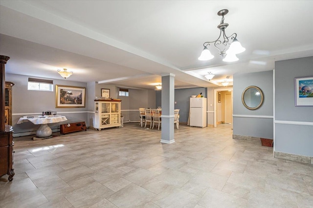 interior space featuring baseboards and a notable chandelier