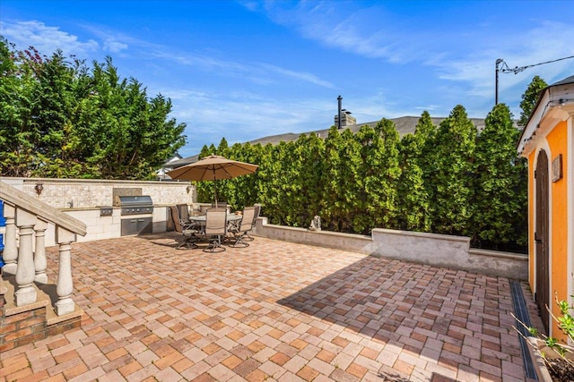 view of patio featuring outdoor dining space, a grill, and area for grilling