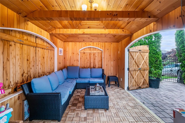 living room with wood walls and wood ceiling