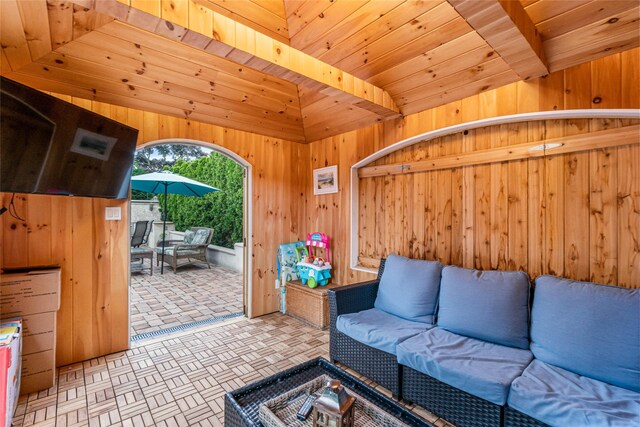 living area featuring wood walls and wooden ceiling