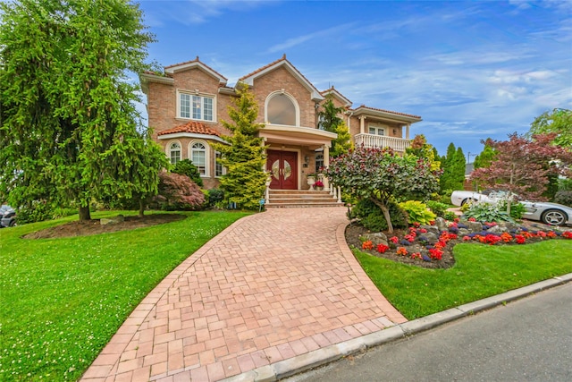 view of front of property with a tiled roof and a front yard