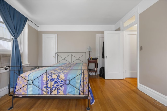 bedroom with wood finished floors and baseboards