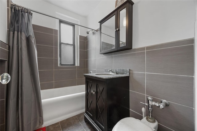 full bath featuring toilet, shower / bath combination with curtain, tile walls, tile patterned floors, and vanity