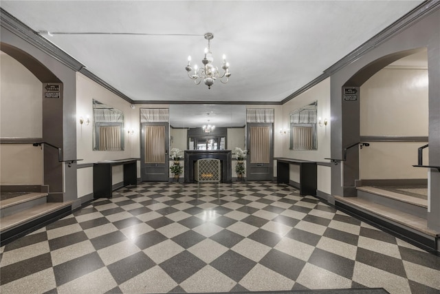 unfurnished living room with stairway, arched walkways, a notable chandelier, and ornamental molding
