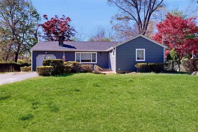89 Christian Ave, Stony Brook, NY 11790 - ranch-style home with a chimney, roof with shingles, a front yard, a garage, and aphalt driveway