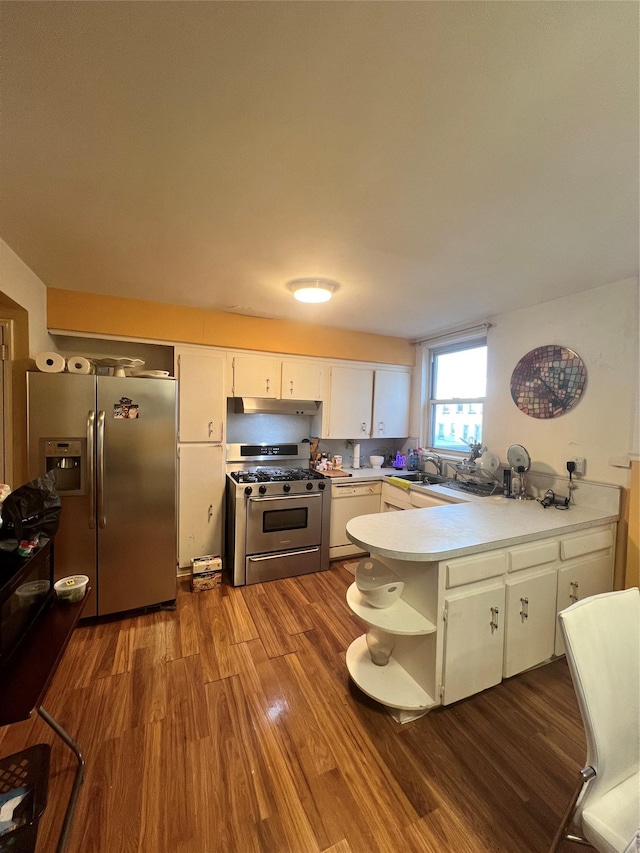kitchen with stainless steel appliances, a peninsula, dark wood-style flooring, white cabinetry, and open shelves