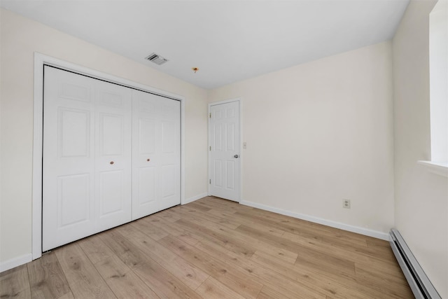 5 Fitzherbert Mews, Middletown, NY 10940 - unfurnished bedroom featuring visible vents, baseboards, a baseboard heating unit, and light wood-type flooring