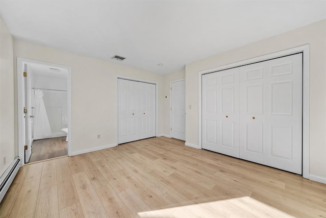 5 Fitzherbert Mews, Middletown, NY 10940 - unfurnished bedroom featuring visible vents, baseboard heating, baseboards, two closets, and light wood finished floors
