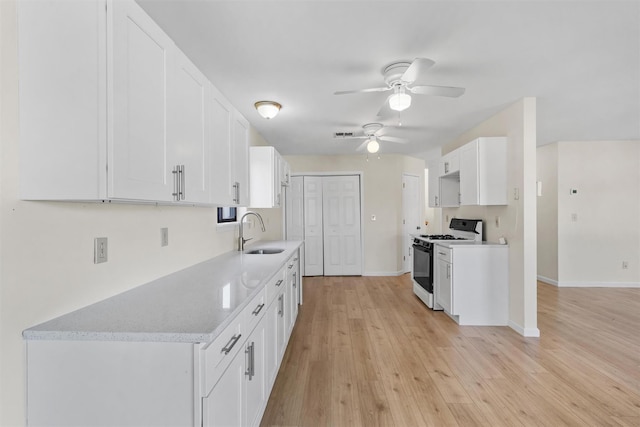 5 Fitzherbert Mews, Middletown, NY 10940 - kitchen featuring a ceiling fan, a sink, baseboards, range with gas stovetop, and light wood-style flooring
