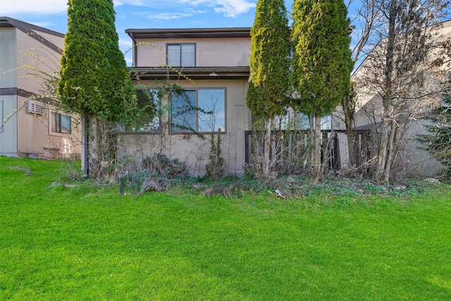 5 Fitzherbert Mews, Middletown, NY 10940 - back of house with a lawn, stucco siding, and a wall unit AC