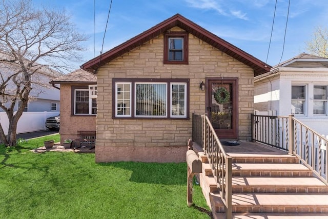 view of front of property featuring stone siding and a front yard