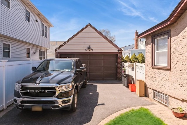 detached garage featuring fence